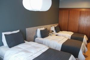 Säng eller sängar i ett rum på Aguada Hotel