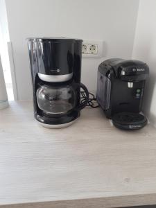 a coffee maker and a toaster sitting on a counter at Ferienwohnungen Albstadt in Albstadt