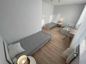 ジェシュフにあるEasy Apartamentyのベッド1台とソファが備わる小さな客室です。