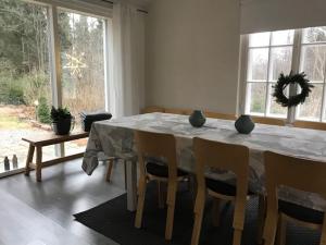 a table that has some chairs around it at Villa Tammikko in Tuusula