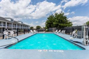 a swimming pool with chairs and a no diving sign on it at Baymont by Wyndham Eden in Eden