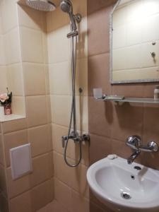 a bathroom with a shower and a sink at Golden House in Varna City