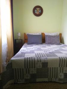 a bedroom with a bed with a quilt on it at Коттедж у Михайла  in Slavske