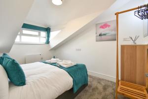 a bedroom with a large white bed in a attic at Windmill View Loft Apartment in York