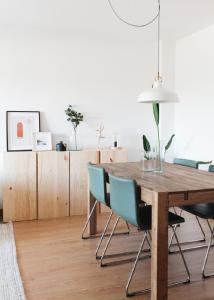 a dining room with a wooden table and chairs at Cozy Panoramic Apartment near Metro Station in Senhora da Hora