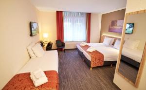 Postel nebo postele na pokoji v ubytování Amrâth Hotel Lapershoek Arenapark