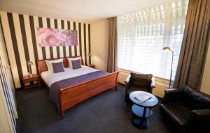 Postel nebo postele na pokoji v ubytování Amrâth Hotel Lapershoek Arenapark