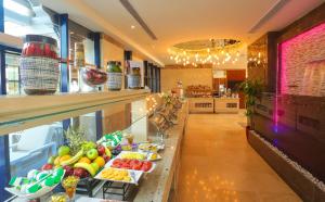 a buffet line with fruits and vegetables on display at Jeddah Oasis Hotel in Jeddah