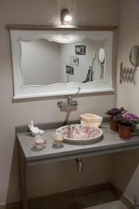 a bathroom counter with a sink and a mirror at Palacio Almagra in Granada