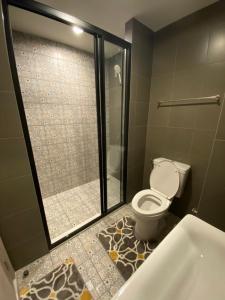 a bathroom with a shower and a toilet and a tub at La casita Hua-Hin seaview by Yaya in Hua Hin