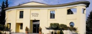 a building with a sign on the front of it at Polo Hotel in Usmate Velate