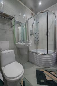 a bathroom with a toilet and a shower and a sink at ОК! Красноармейская, 101 in Tomsk