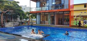 three people in a swimming pool in a building at Seaside Villas An Vien Nha Trang in Nha Trang +139 photos