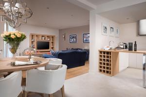 a kitchen and living room with a table and chairs at Villa Petra by HMZ Villas in Vabriga