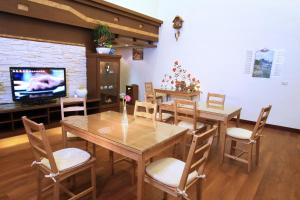 a dining room with a table and chairs and a tv at Winter's Love in Wujie