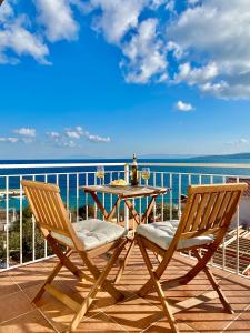 a table and two chairs on a balcony with the ocean at Villa Veli Nova in Zavala