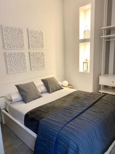 um quarto com uma cama grande e um cobertor azul em FASHION HOUSE ELVIRA 2 em Bérgamo