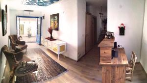 a living room with a wooden table and chairs at Lavinia Otel in Cesme