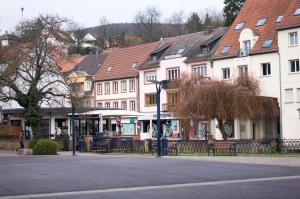 a street in a town with buildings and a street light at Meublé tout confort, avec terrasse in Niederbronn-les-Bains