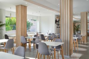 a dining room with tables and chairs at Rose Hotel Faliraki in Faliraki