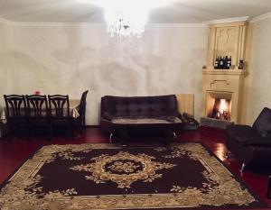 a living room with a couch and a fireplace at Butichi Guest House in Chiatʼura