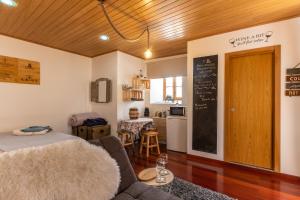 a living room with a couch and a chalkboard at Wine Inn Studio in Sintra