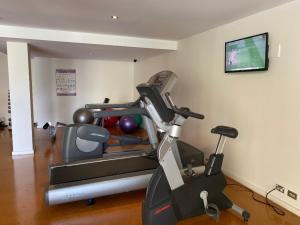a room with a gym with a treadmill and a tv at ARENA RESORT STYLE EXEC FREE NETFLIX WIFI WINE in Perth