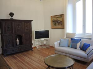 a living room with a couch and a tv at Casa Augusto in Bellinzona