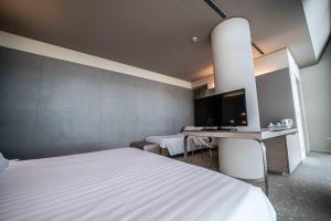 a bedroom with a bed and a desk and a tv at Best Western Plus Net Tower Hotel Padova in Padova