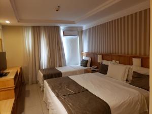 Кровать или кровати в номере Hotel Astoria Palace