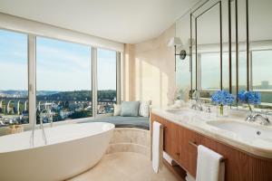a bathroom with a tub and a large window at Corinthia Lisbon in Lisbon