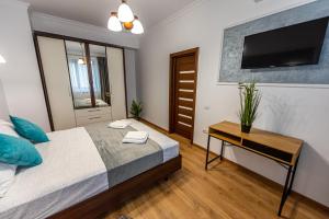 En eller flere senge i et værelse på Sunrise MAMAIA