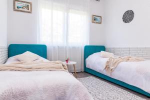 two beds sitting next to each other in a bedroom at Holiday Home Istra with JACUZZI in Medulin +38 photos