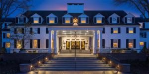 an exterior view of a white house at night at Woodstock Inn & Resort in Woodstock