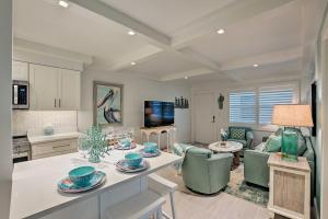 a kitchen and living room with a table and chairs at Coastal Downtown Naples Condo - Walk to the Beach! in Naples