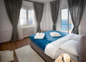 a bedroom with a large bed and a large window at Seafront Luxury President Suite Aegean Sunset in Thessaloniki