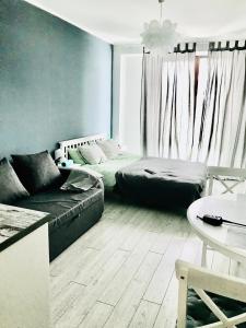 a living room with a bed and a couch at New Gudauri Loft 2,apart 106 in Gudauri