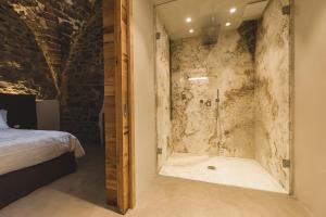 a bathroom with a walk in shower in a room at Torre di Baratti Bio Resort in Populonia +37 photos