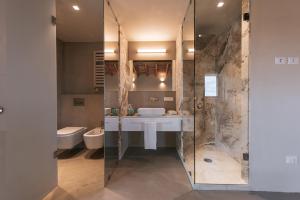 a bathroom with a shower and a sink and a toilet at Torre di Baratti Bio Resort in Populonia