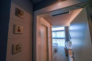 a room with a hallway with a door and a window at Best Western Plus Net Tower Hotel Padova in Padova