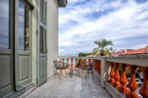 a balcony with two chairs and a table on it at Impero Nafplio Hotel & Suites in Nafplio