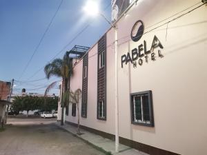 a building with a sign on the side of it at Hotel Pabela in Ocotlán