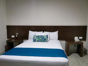 Ένα ή περισσότερα κρεβάτια σε δωμάτιο στο Hotel Pabela