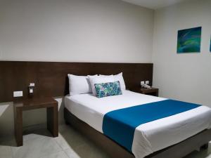Ένα ή περισσότερα κρεβάτια σε δωμάτιο στο Hotel Pabela