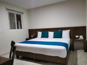 Ένα ή περισσότερα κρεβάτια σε δωμάτιο στο Hotel Pabela