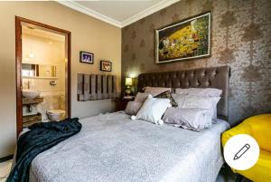 a bedroom with a large bed and a bathroom at Edifício Andressa in Florianópolis