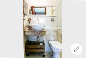 a bathroom with a sink and a toilet at Edifício Andressa in Florianópolis +31 photos