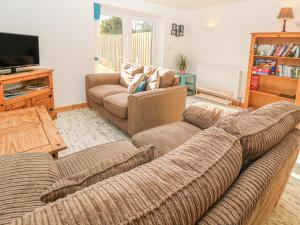 a living room with two couches and a television at The Packing House in Penzance