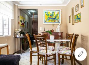 a dining room with a table and chairs at Edifício Andressa in Florianópolis
