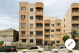 a large building with cars parked in front of it at Edifício Andressa in Florianópolis